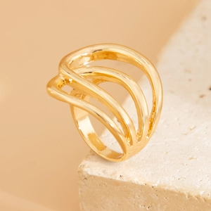 Macro shot of gold layered wavy ring with irregular three-tier design on stone base