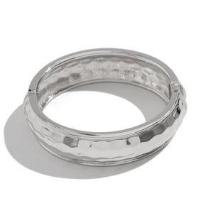 Silver geometric bangle with hammer-textured honeycomb pattern and side hinge closure