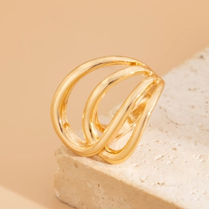 Detailed view of triple-layered golden wavy ring with polished finish on stone