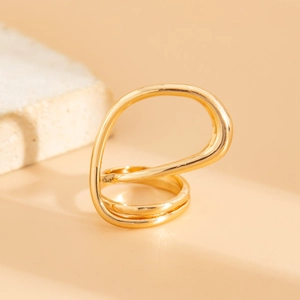Detail of minimalist gold double-layer ring with abstract water drop design on stone