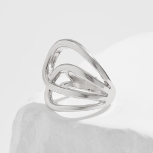 Detailed macro view of abstract multi-layer silver geometric ring with high-polish finish