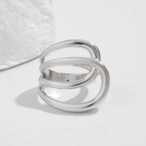 Detailed view of irregular polished silver multilayer wave ring with minimalist 3D design