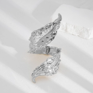 Exaggerated silver leaf bypass bracelet with textured vein details in a minimalist style