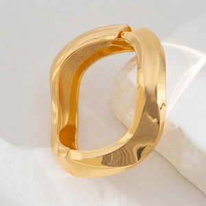 Chic gold-plated irregular twisted wide cuff bracelet with a polished metallic finish
