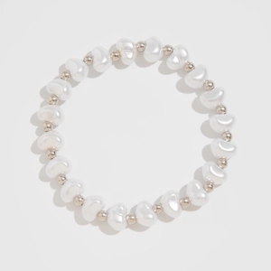 Macro view of minimalist irregular freshwater pearl bracelet with silver metallic beads