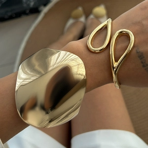 Irregular wide gold cuff and teardrop open bracelet set for a trendy fashion look