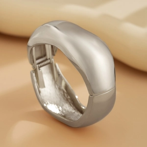 Minimalist silver wide metal cuff bracelet with polished finish and hinge closure