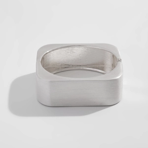 Detailed view of silver square metal cuff bracelet with a brushed matte finish surface