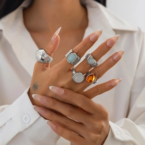 Close-up of 5-piece luxury alloy ring set with colorful acrylic stones on a model hand