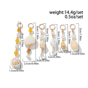 Detail view of Bohemian shell earrings set showing dimensions and various sea-inspired charms