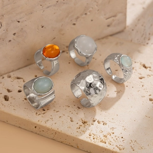 Detailed view of vintage silver alloy rings set with acrylic stones and hammered texture