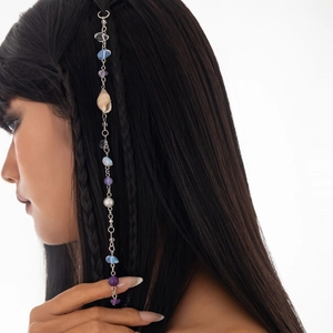Détail de pince à cheveux bohème avec perles violettes et gland en coquillage