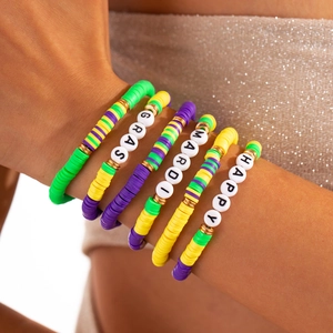 Detail of Mardi Gras beaded bracelet set with purple green and gold clay heishi disks