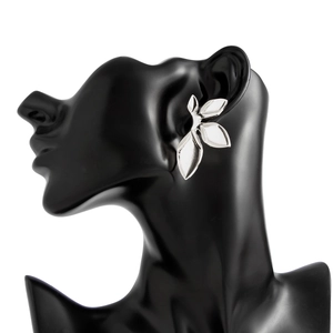 Detailed view of silver leaf-shaped earrings featuring overlapping metallic petals