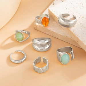 Set of 7 silver adjustable rings with colorful oval acrylic inlays on stone props
