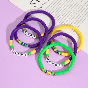 Detail of purple, gold and green Heishi bead Mardi Gras bracelets with letter charms