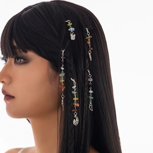 Detail of colorful stone braid charms with moon and heart metal pendants for hair