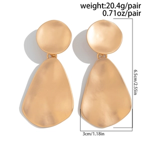Detail view of large gold geometric drop earrings with dimensions 6.5x3cm and weight 20.4g