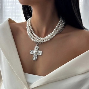 Three-layer pearl necklace featuring a vintage silver cross pendant with pearl accents