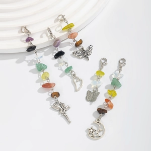 Detail of bohemian stone pendants featuring colorful raw crystals and silver metal charms