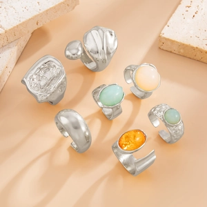 Detail of a six-piece silver ring set featuring hammered textures and oval gemstones