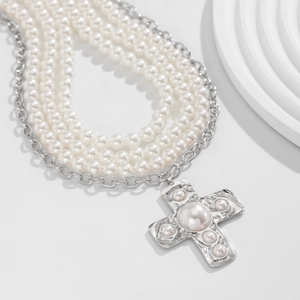 Baroque layered pearl necklace with silver cross pendant and multi-strand design