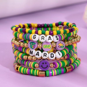Stackable Mardi Gras clay bead bracelet set with gold beads and festival charms