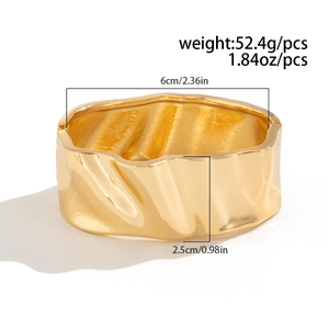 Detailed view of wide gold wavy bangle with 6cm inner diameter and 2.5cm width dimensions