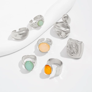 Detailed set of seven silver-tone rings with acrylic stones and irregular textures