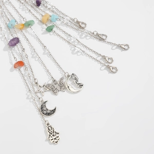 Macro shot of silver metal chains with colorful natural stones and ethnic charms