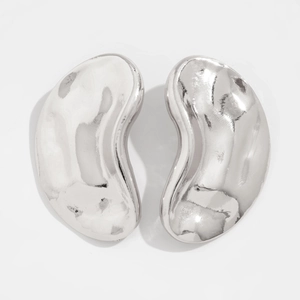 Close-up of bean-shaped silver stud earrings with a high-polished mirror finish