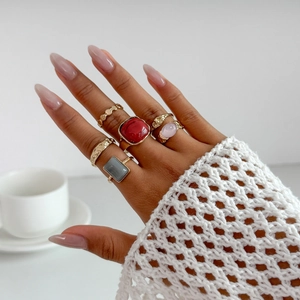 Chic 5-piece gold alloy ring set with assorted acrylic gemstones worn by a model