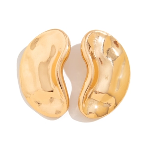 Macro detail of gold-toned irregular water-drop earrings with a polished hammered finish