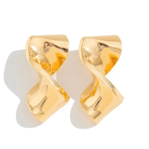Macro detail of high-polish gold twisted spiral earrings with irregular texture