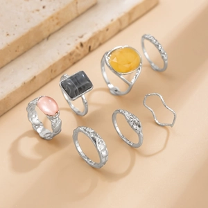 Detailed set of 7 alloy rings featuring yellow faceted gems and textured silver bands