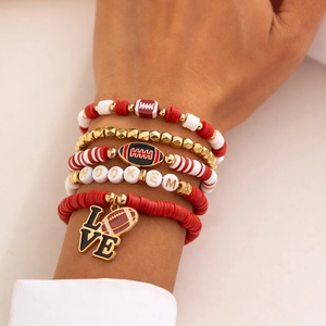 Detail of five-piece stacked football bracelets with red clay beads and charms