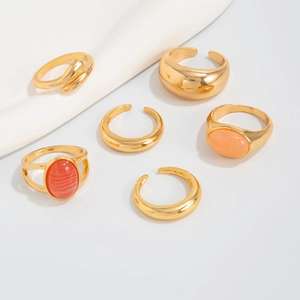 Detailed view of a 6-piece gold alloy ring set featuring red and pink acrylic stones