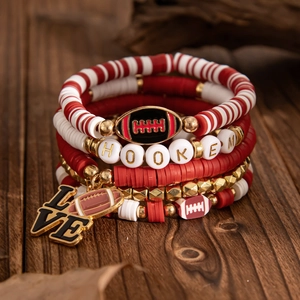 Detail of multi-layer beaded bracelets with football pendant and HOOKEM letter beads