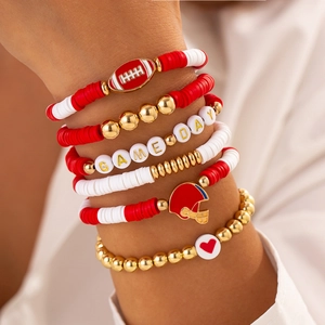 Macro shot of stacked Game Day bracelets featuring acrylic beads and sports charms