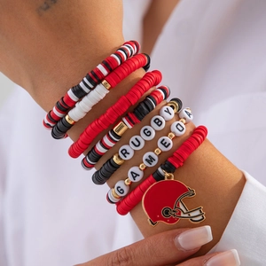 Detail of red and black beaded bracelets with RUGBY letters and football helmet charm