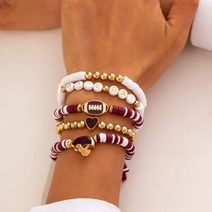 Stack of 5 burgundy and gold beaded bracelets with Game Day letters and rugby charms