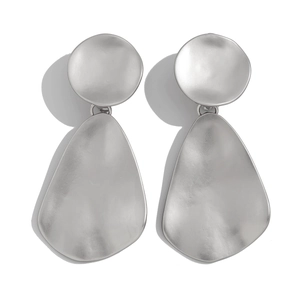 Detail view of silver water drop earrings with unique hammered texture and geometric design