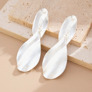 Detailed view of silver irregular teardrop earrings with a textured hammered finish