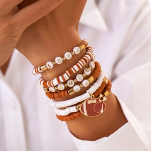 Detail of multi-layer beaded bracelets with football charms and gameday lettering