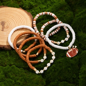 Detail of bohemian heishi bead bracelets with LOVE and GAME DAY lettering and football charm