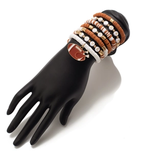 Detail of stacked clay bead bracelets with football charm and GAMEDAY letter beads