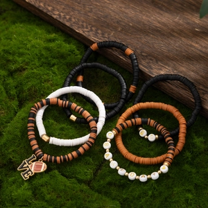 Detail of layered Super Bowl bracelets with heishi beads and Game Day letter charms
