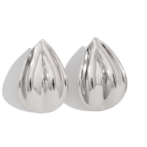 Macro view of water-drop silver stud earrings with vertical ribbed texture and 3D design