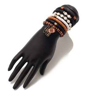Detail of layered Gameday clay bead bracelets with football charms on a display model