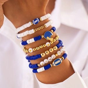 Detail of stacked bohemian game day bracelets with acrylic beads and football charms